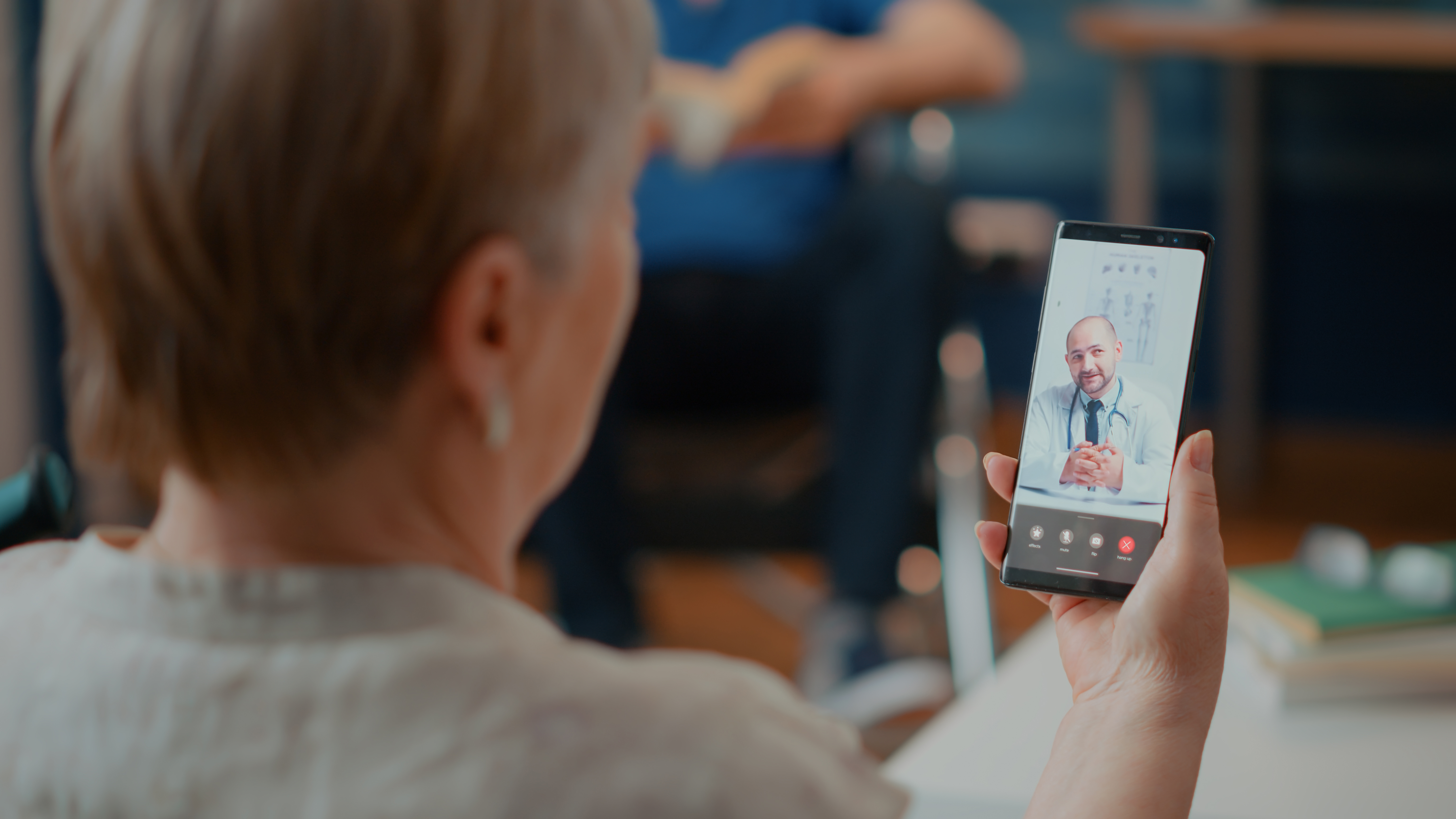 Senior adult attending online video consultation with doctor